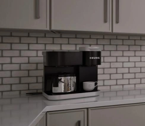 Tiny Kitchen Design Ideas featuring a compact black mini coffee machine with a metallic pot and white cups against a light gray brick wall.