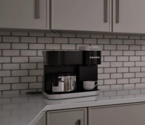 Tiny Kitchen Design Ideas featuring a compact black mini coffee machine with a metallic pot and white cups against a light gray brick wall.