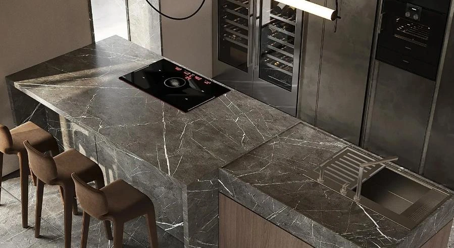 Tiny Kitchen Design Idea featuring a gray marble countertop with white veining and a built-in cooktop and sink.