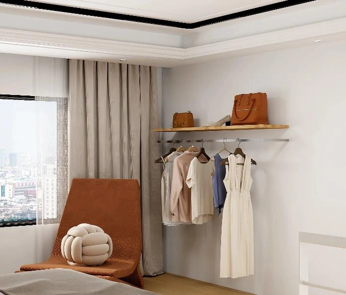 Minimal clothes rack with hanging garments and wooden shelves in a studio apartment.