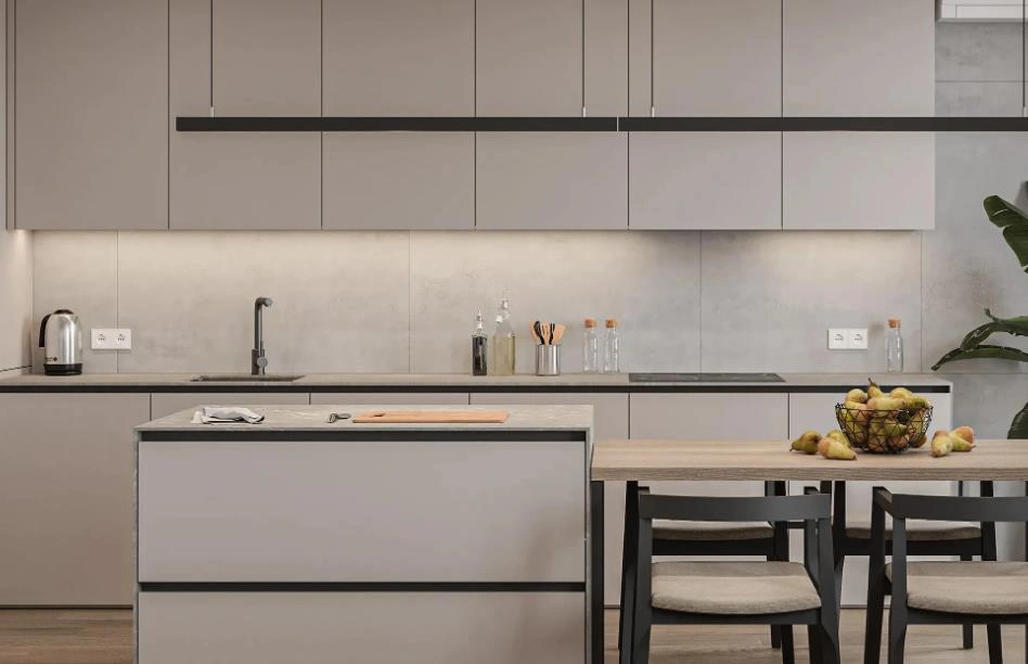 Tiny open kitchen design with light gray cabinets connected to a wooden dining table.