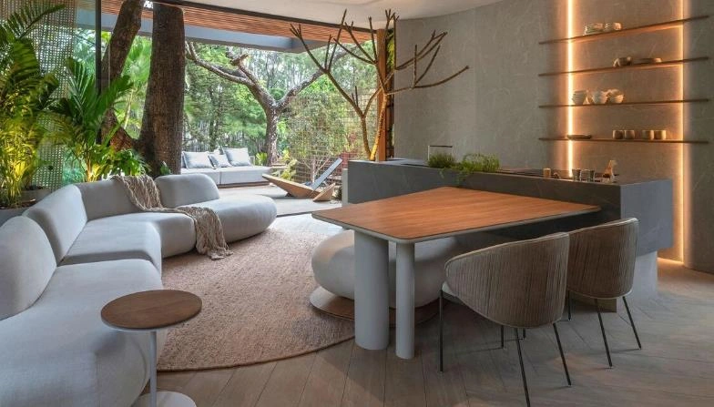 White marble island connecting kitchen and dining area in a small apartment.
