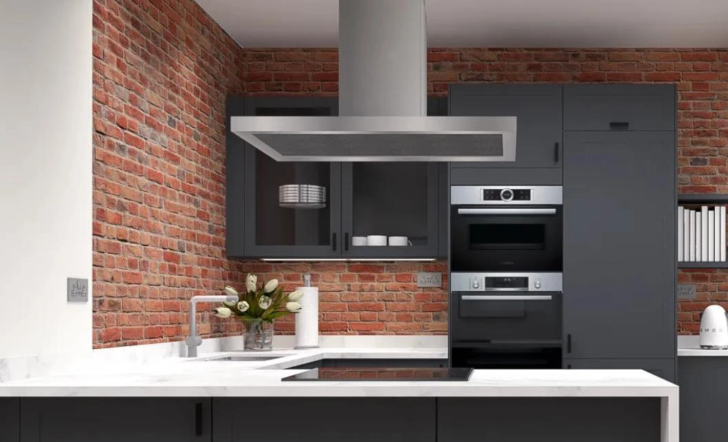 Tiny kitchen design featuring an industrial red brick wall contrasting with dark gray cabinets.