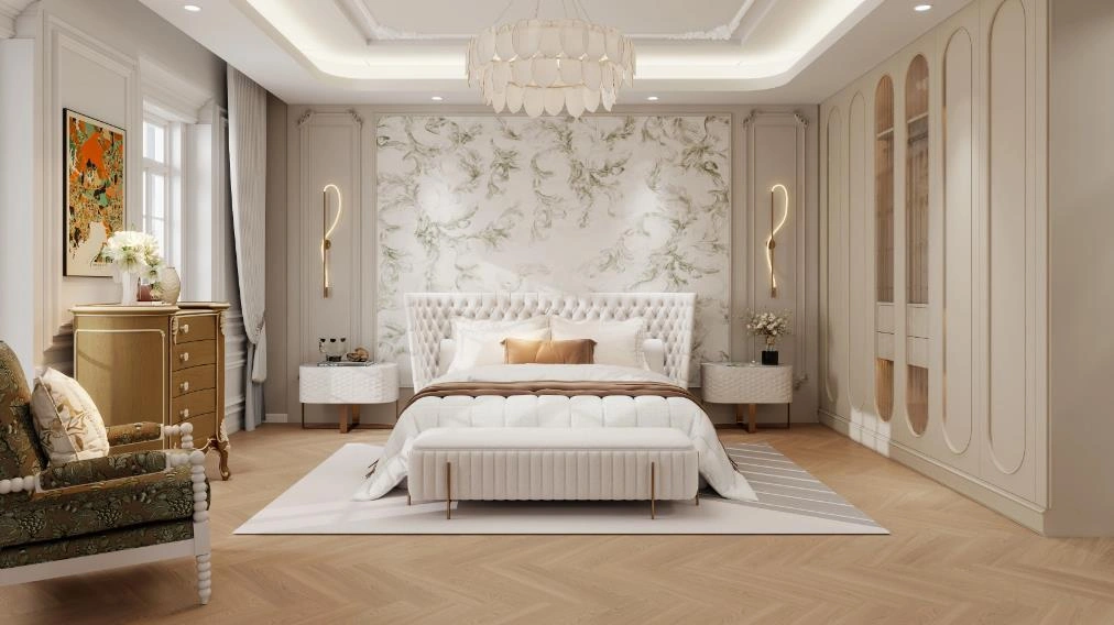 French luxury bedroom for women with marble accent wall, gold wall lamps, and floral armchair.