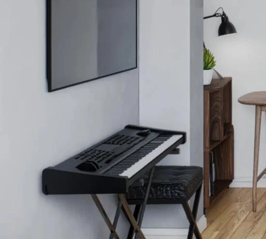 Black keyboard placed in the corner adds musical charm to the small living room.