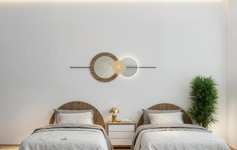 Tiny bedroom with two closely placed beds, wooden curved headboards, and a shared white bedside table.