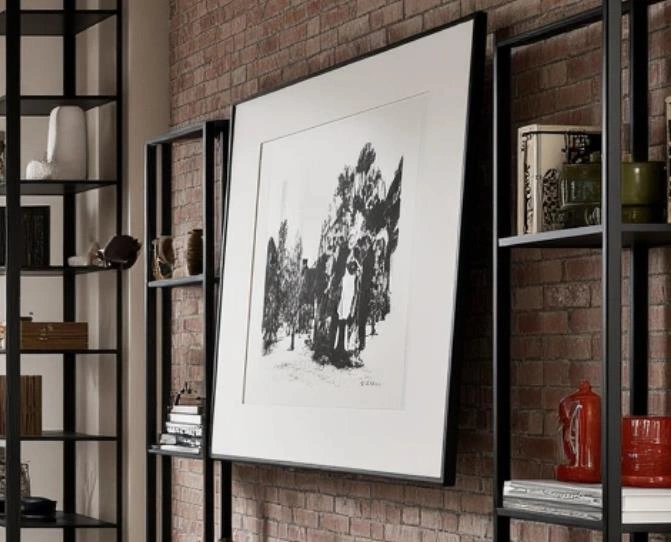 Large black-and-white botanical painting hanging in a small living room.