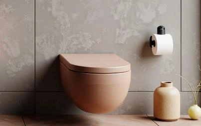 Modern wall-mounted toilet with concealed tank in a small apartment bathroom.