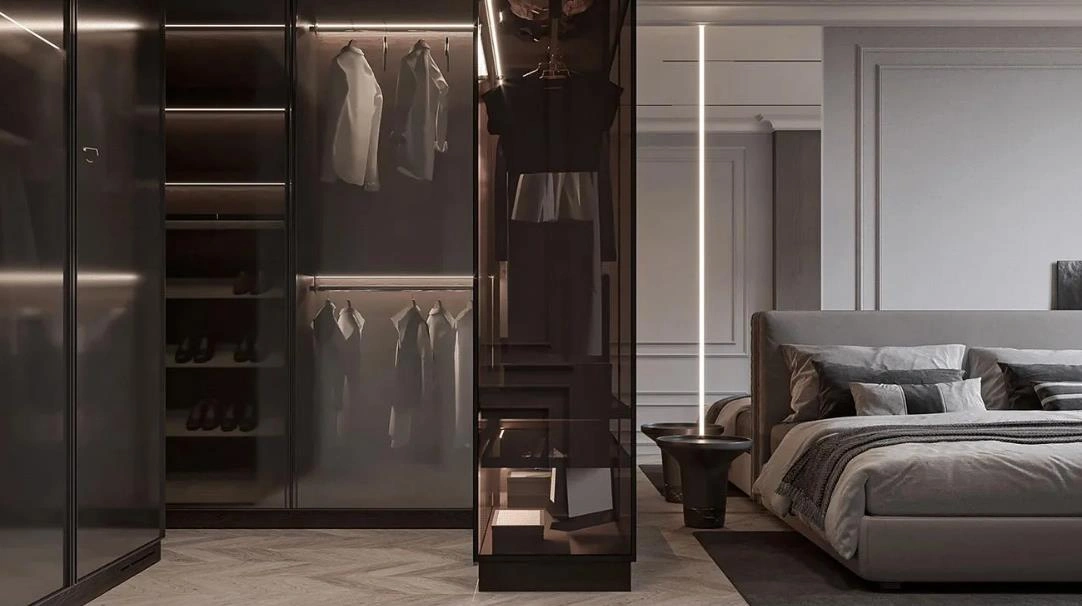 Neutral-style women&rsquo;s bedroom with gray bedding, black-glass wardrobe, and minimal d&eacute;cor.