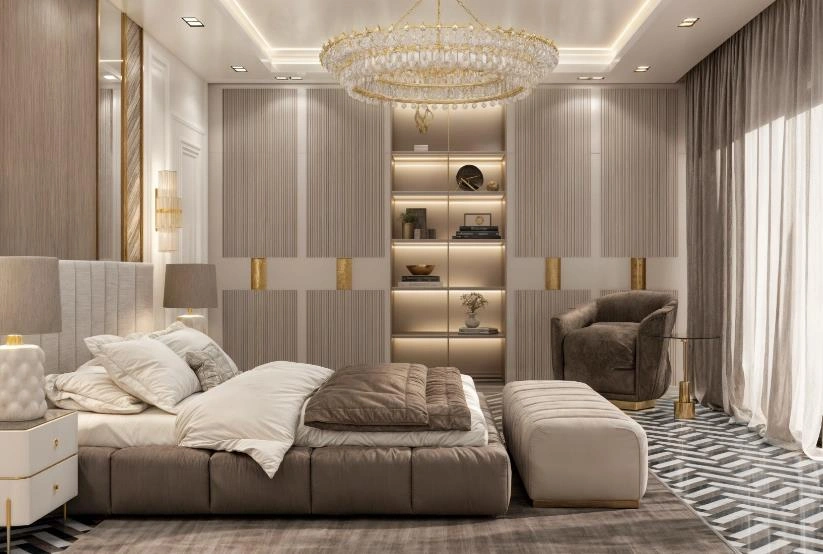 Luxurious women&rsquo;s master bedroom featuring a crystal chandelier, velvet seating, and gold-accented cabinetry.