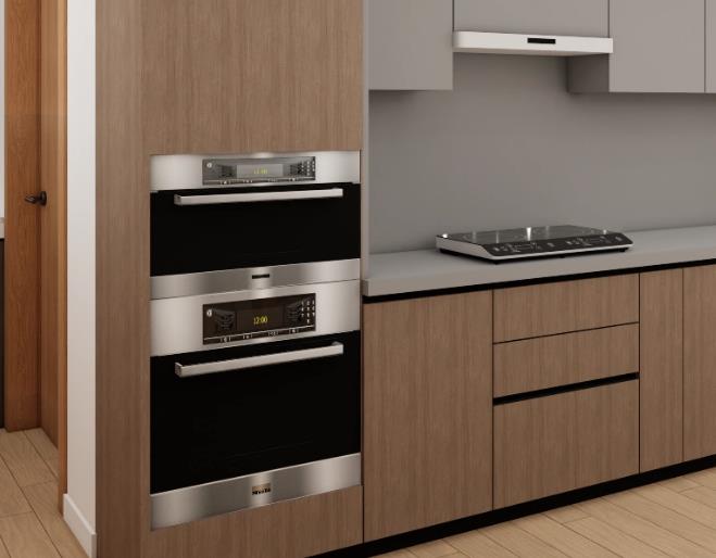 Tiny kitchen design featuring a built-in double oven with a silver frame and a compact induction cooktop.