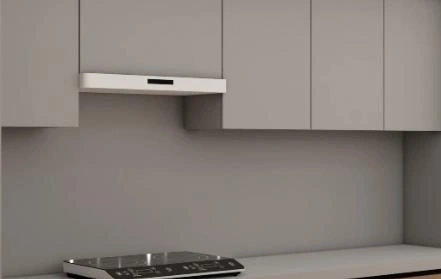 Built-in concealed range hood integrated with gray cabinets in a small kitchen.