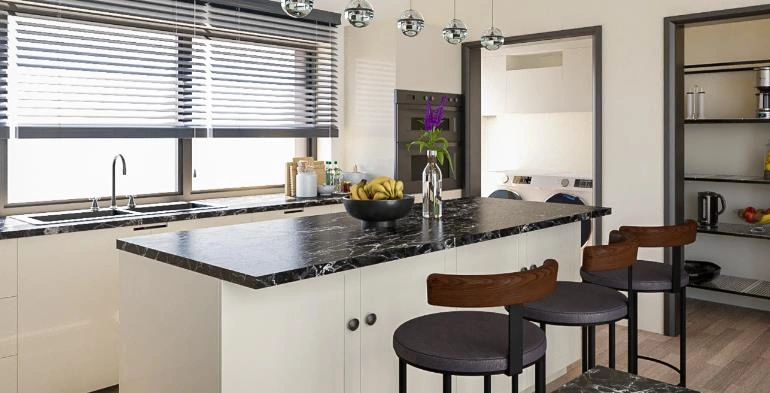Black-and-white marble kitchen island with wooden bar stools in a tiny apartment.