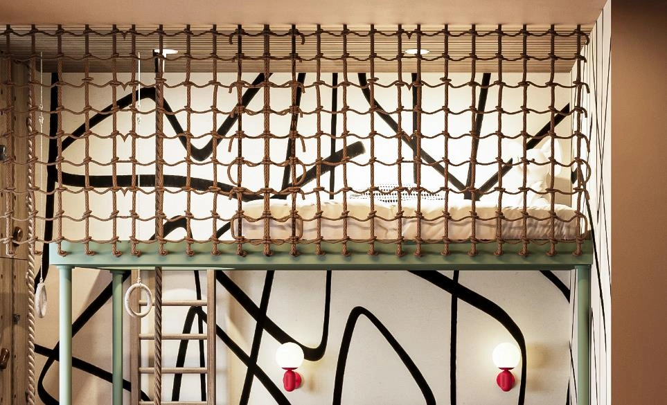 Ceiling with rope net for fun, adventurous children’s room design.