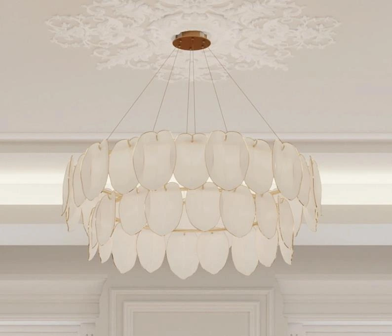 Layered petal-style chandelier with gold frame in a small apartment.