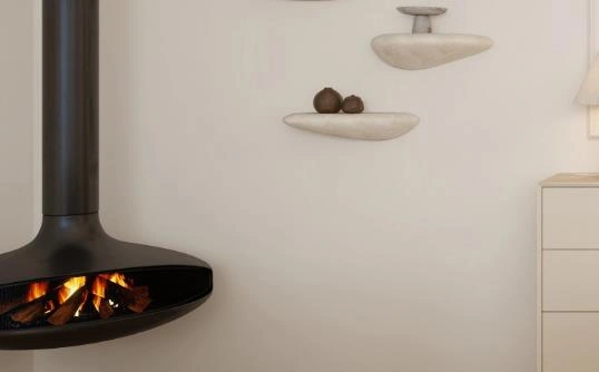 Black wall-mounted stove with vertical chimney in a small living room.