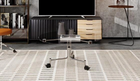 Transparent round coffee table with metal frame and casters in a small living room.
