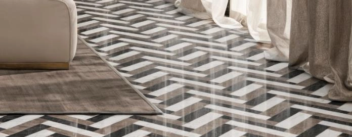 Black-and-white herringbone floor tiles paired with gray bedding.