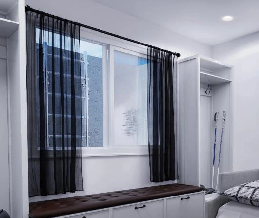 Black sheer short curtains add a cool, modern touch to a guy’s bedroom.