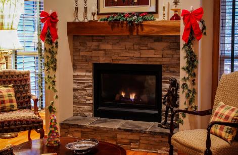 A wicker wreath is hanging by the fireplace