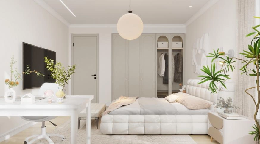 A warm cream bedroom with an upholstered headboard and a tidy study nook