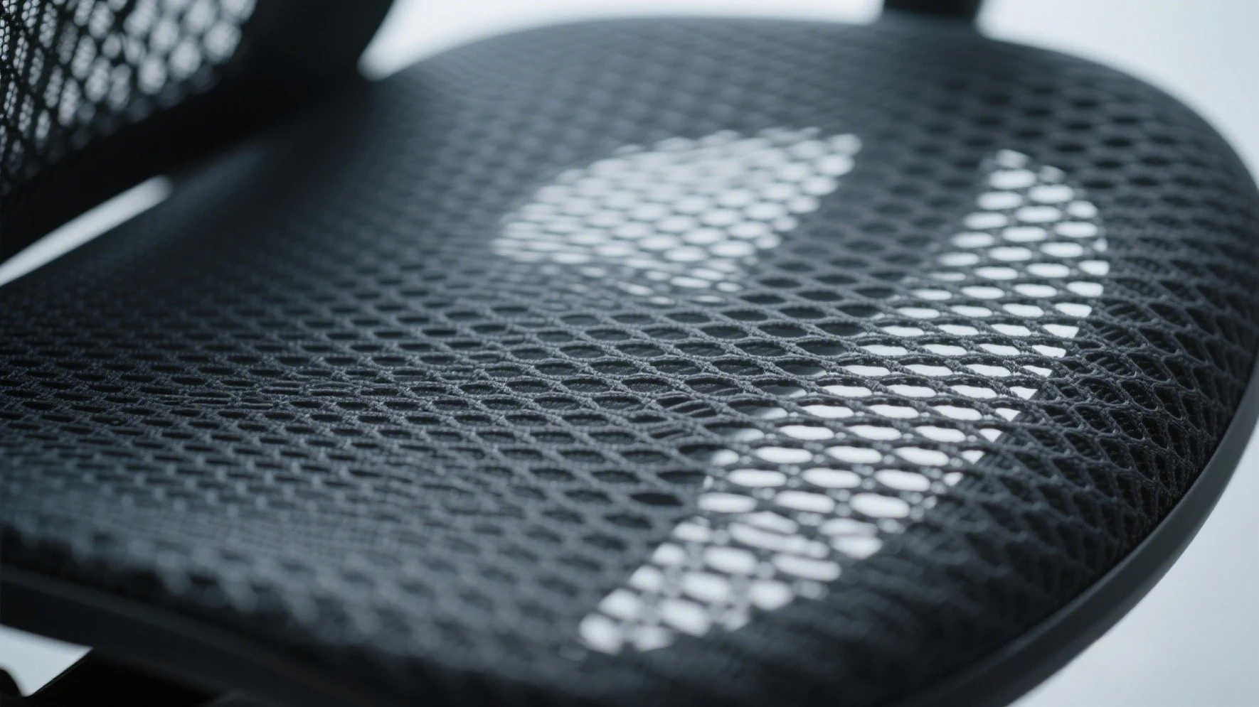 Close-up of mesh ergonomic chair seat